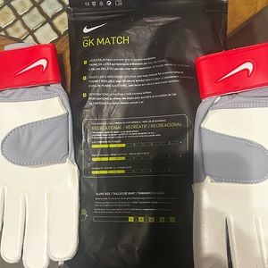 Red Game Day Nike goal keeper gloves. Too large so never used.